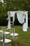 Wedding ceremony in the open air.Transparent chairs with fluttering ribbons in the Park or forest. Arch decorated with