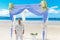 Wedding ceremony on a tropical beach in blue.The groom waits for