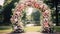 Wedding ceremony. Very beautiful and stylish wedding arch, decorated with various fresh flowers, standing in the garden. Wedding