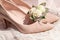 Wedding classic accessories: Bride`s beige shoes, rings, boutonniere and wedding bouquet