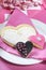 Wedding cookies on pink bridal table - vertical closeup.