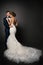 Wedding Couple, Beautiful Bride in White Dress with long train tail, Elegant Groom Kissing Romantic Studio Portrait