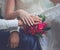 Wedding couple, bride and groom, hands with rings and pink gentle bouquet flowers closeup, country, rustic style