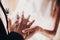 Wedding couple exchanging wedding rings during holy matrimony in church. Bride and groom putting golden rings on finger, close up