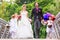 Wedding couple with flower children on bridge