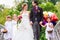 Wedding couple with flower children on bridge