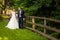 Wedding couple in forest near fence