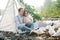 Wedding couple, groom and bride near wedding arch on a background mountain river