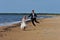 Wedding Couple jumping on the Beach.