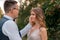 Wedding couple looking at each other with love and happiness at park at sunset time