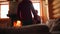 Wedding couple in love warming up in red sweaters by the fireplace. Bride and groom relax and kiss by warm fire and