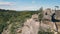 Wedding couple in mountain rock from drone. Aerial view Happy newlyweds in love hugging standing on top of the mountain.