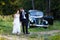 A wedding couple with old car