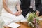 Wedding couple with rings and bouquet on table