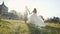 Wedding Couple Runing in grass Field near Castle on Sunset