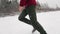 Wedding couple runing in snowy winter during snowfall. Low angle shot of feet in leather boots stepping on fresh snow