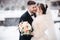 Wedding couple in winter time walking outside. Handsome bearded groom kiss beautiful bride