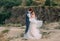 Wedding day. The bride and groom tenderly embrace each other against the backdrop of wildlife at sunset.