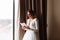 Wedding day. Fees at the hotel. the bride near the window and reads the letter to the groom. Wedding vows. Preparations