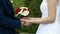 On a wedding day the groom strokes the bride`s hand, the wedding bouquet