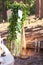 Wedding decor in forest. Mirror, twigs, candles