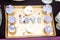 Wedding decor, LOVE letters on tray with blue colored muffins. LOVE decoration on festive table. Luxurious wedding decoration