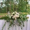 Wedding decor. Table for the newlyweds outdoor. Wedding reception. Elegant wedding table arrangement, floral decoration, restauran