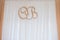 Wedding decoration letter O & B. Wooden initials of newlyweds hang on the wall