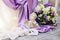 Wedding decoration in white and purple colors: shiny fabrics, angel figure, candles