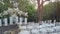 Wedding decorations flowers and white chairs, in a forest environment after the ceremony.