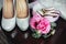 Wedding details, decoration. Bouquet of pink roses, bridal accessories and macaroons stand on a wooden table. Soft focus