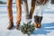 Wedding details, shoes of stylish wedding, wedding bouquet. pine-tree bouquet. brown shoes. close up. snowy road on the background