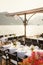 Wedding dinner table reception. Rectangular tables with white tablecloth, floral arrangements lemons in vases. Yellow