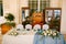 Wedding dinner table reception. White rectangular table of newlyweds with four chairs, white-blue tablecloth, floral