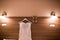 Wedding dress hanging on the wall in the room and bridal beige shoes. Image of the bodice of a beige wedding dress on a wooden whi