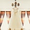 A wedding dress hangs on a chandelier