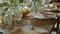 wedding festive table set with plates with peach down napkins and fresh flowers