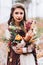 Wedding floristry in a yellow autumn meadow in the hands of a girl dressed in the style of boho.