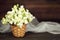 Wedding flower decoration. White snapdragon flowers in woven basket