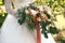 Wedding gentle disheveled bouquet of peach shades with pink ribbon