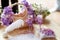 Wedding glasses with champagne stand behind a pretty basket decorated with violet flowers
