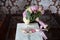 Wedding gold rings and bouquet of flowers on a dark wooden table. Concept marriage.