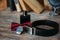 Wedding groom accessories, details of clothes, belt, wristwatch, boutonniere, bow-tie, perfume.