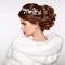 Wedding Hairstyle. Attractive girl in white fur coat. Jewelry Ea