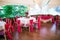 Wedding hall with red coloured chairs and tables