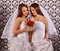 Wedding lesbians girl in bridal dress keeps flowers.