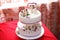 Wedding mastic cake decorated with flowers and cat figures, closeup