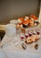 Wedding menu. Serving a wedding candy bar. A composition of sweet cakes and cookies, desserts in cups and roses in a vase on a