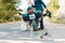 Wedding, newlyweds. Hugs and kisses of a man and a woman in wedding dresses, near a motorcycle. Road on the background