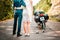 Wedding, newlyweds. A man and a woman in wedding dresses and motorcycle helmets embrace and look at the road and the motorcycle in